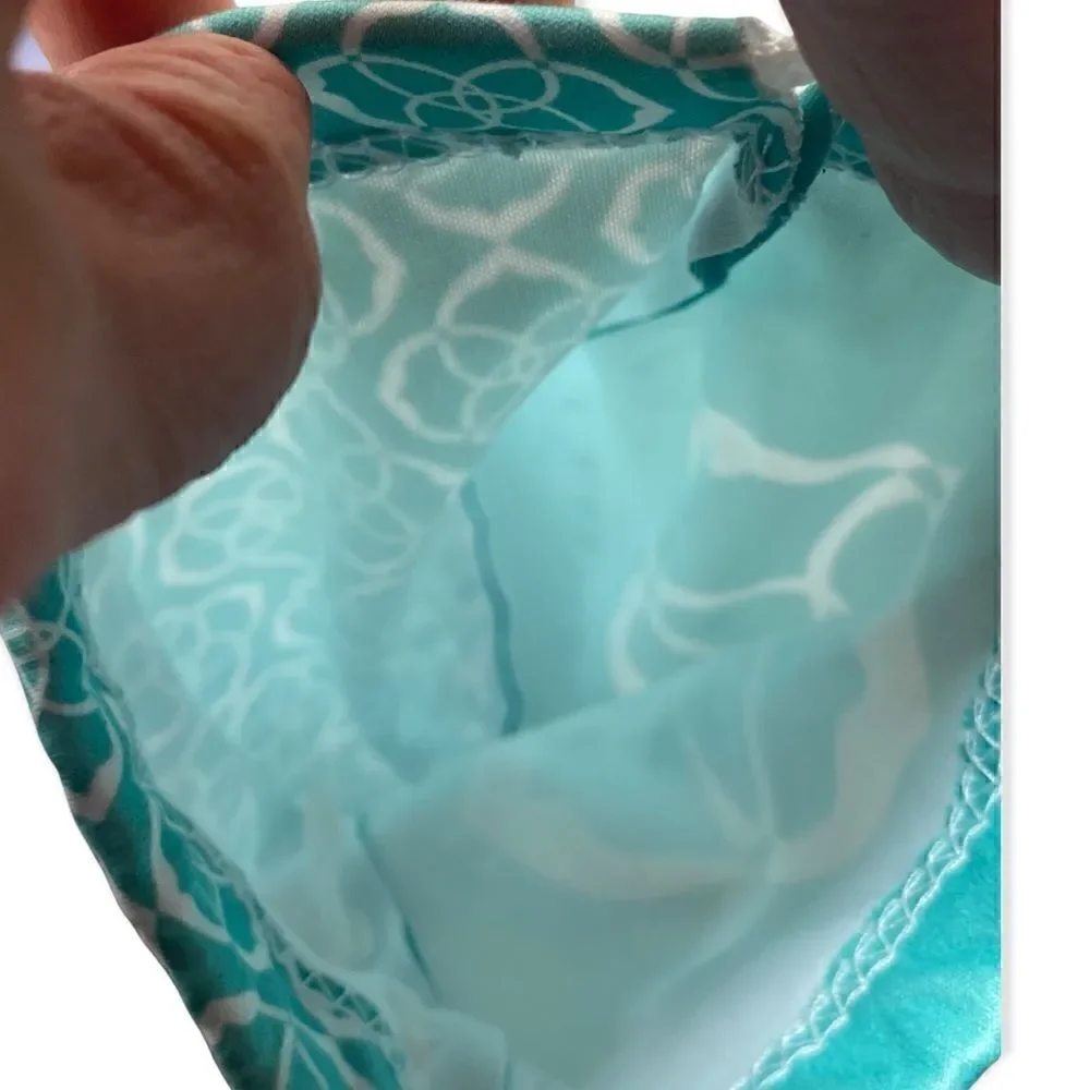 Kendra Scott jewelry bag in turquoise with white signature pattern drawstring